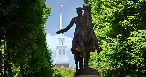 Paul Revere statue on the historic Boston Freedom Trail with the Old North Church steeple in behind in Boston Massachusetts USA photo