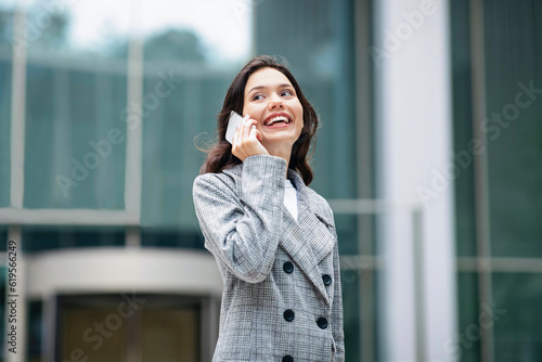 Young Business Woman Talking On Mobile Phone In Urban Area