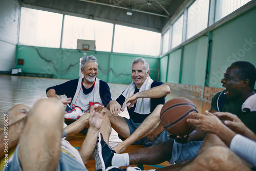 Senior men taking a break from playing basketball in an indoor gym