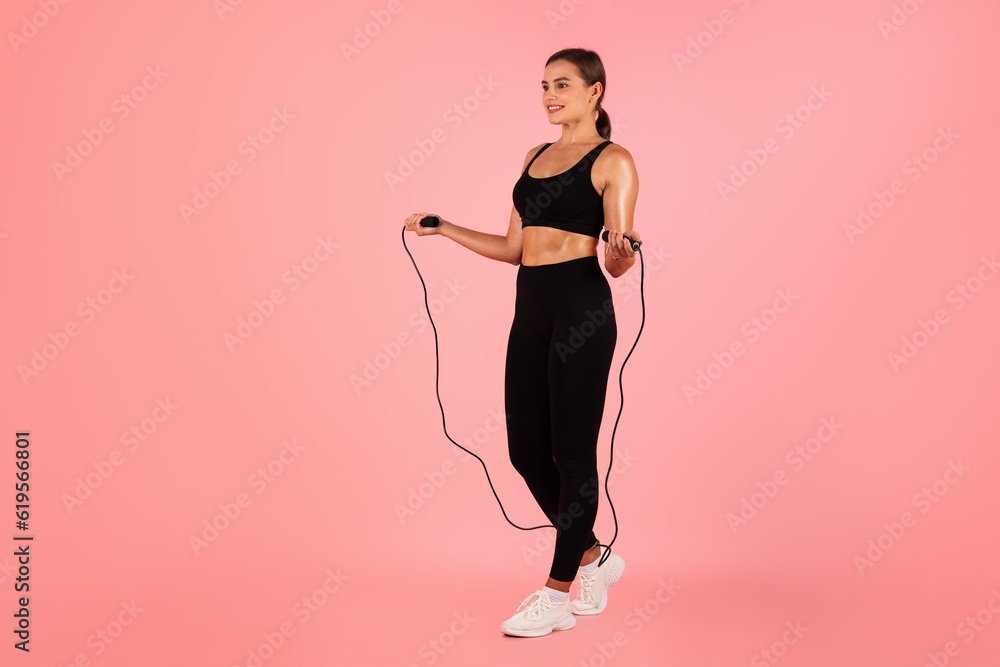 Cardio Workout. Portrait Of Sporty Young Female In Activewear Holding Skipping Rope Cardio Workout. Portrait Of Sporty Young Female In Activewear Holding Skipping Rope