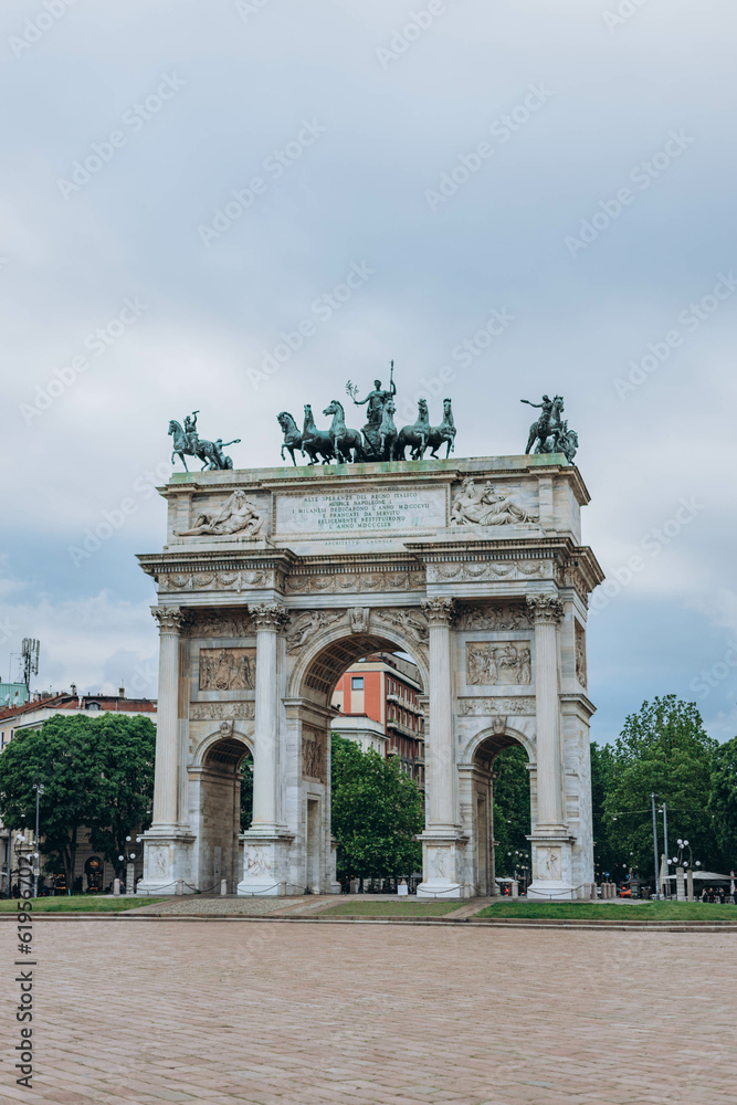Milan, Italy- May 13, 2023: Arch of Peace or Sempione Gate in Milan, near Sempione Park. Exterior view of the marble gate of the Arco della Sempione, a peace memorial in Milan. Visiting from the park.