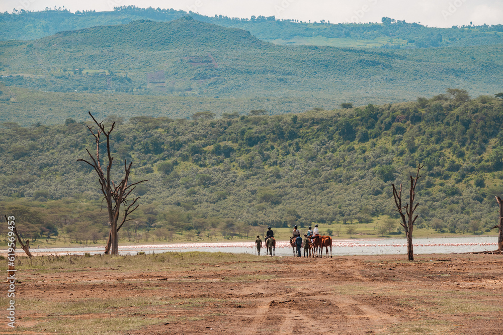 Visitors riding horses along the shore of Lake Elementaita in Soysambu Conservancy, Kenya