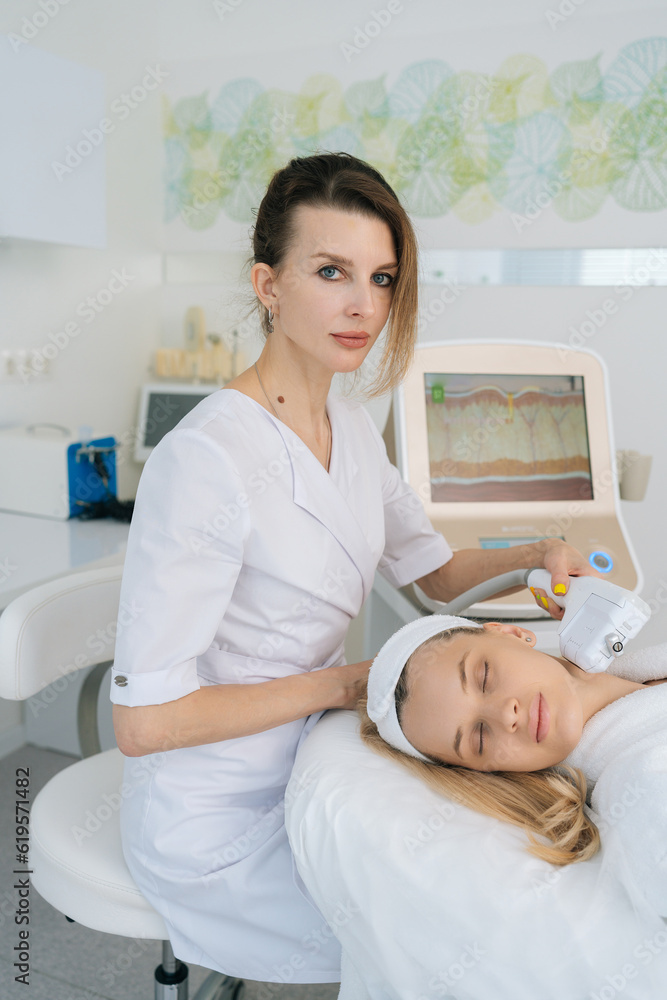 Vertical portrait of beautician doctor using laser machines and ultrasound SMAS lifting to rejuvenate skin in beauty clinic. Concept of non-surgery cosmetology, professional skincare, beauty treatment