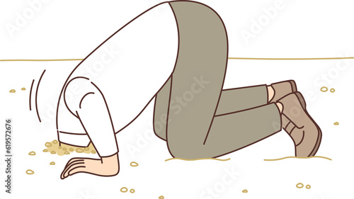 Man hides head in sand like ostrich from proverb, for concept of denial of problems and cowardice