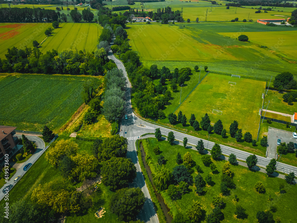 Top view of the road in the province of Milan. Summer drone photo in Italy. 