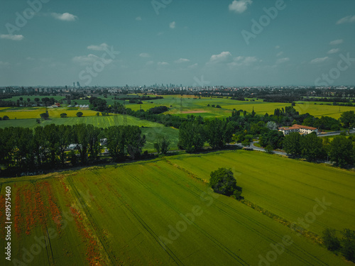 Aerial view of Poasco in Italy surrounded by fields and countryside. Milan, Lombardy Aerial photo. Top view of countryside and green fields. Country Life Concept. Aerial photography in the summer. 