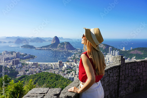 Fashion tourist woman on terrace in Rio de Janeiro with the famous Guanabara bay and the cityscape of Rio de Janerio, Brazil photo