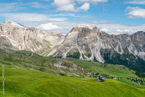 Helicopter in the rocky Dolomites of Italy.