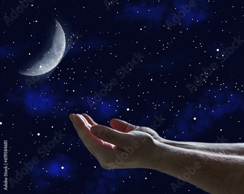 Muslim human hands praying on moon and night sky