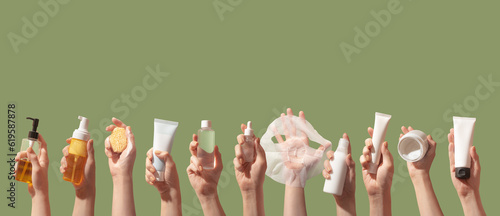 Korean care system cosmetic bottles, jars, tubes green background. Peeling, cleansing oil, mask, foam, toner, shit mask, sun cream