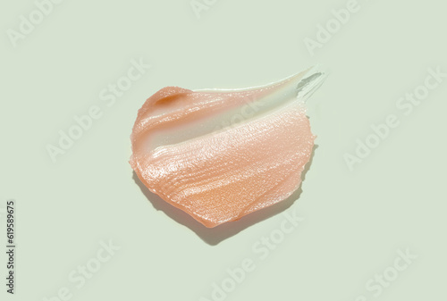 Cosmetic products creamy honey yellow orange texture smudge beige background