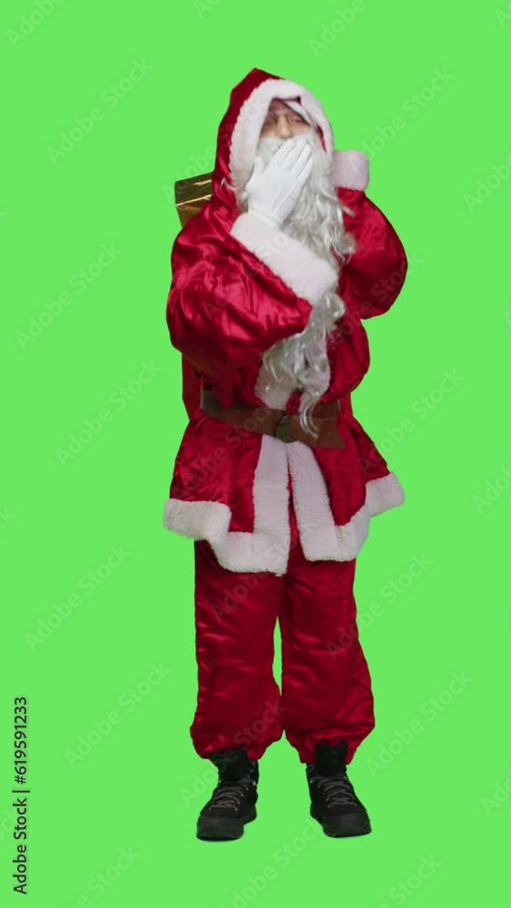 Vertical video Front view of flirty santa claus gives air kisses to spread positivity and chrsitmas spirit, acting romantic and sweet over full body greenscreen. Young man dressed as saint nick in Vertical video Front view of flirty santa claus gives air kisses to spread positivity and chrsitmas spirit, acting romantic and sweet over full body greenscreen. Young man dressed as saint nick in