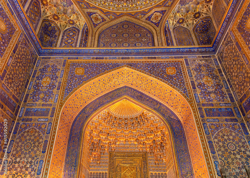 Interior of Tilya Kori Madrasah in Samarkand, Uzbekistan. Masterpiece of XVII century. Mihrab upper part, golden and blue ornaments