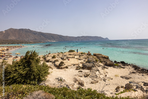  People relaxing on the famous pink coral beach of Elafonisi on Crete, Mediterannean sea, Greece
