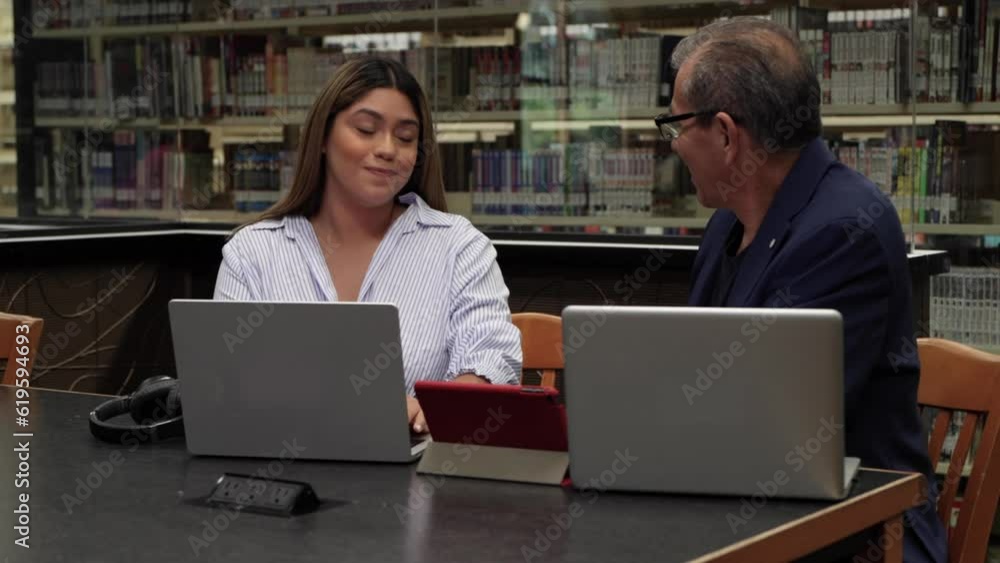 Woman and man working and studying in the office doing teamwork flirting Woman and man working and studying in the office doing teamwork flirting