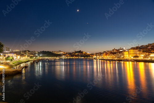 skyline in the evening freom dom luiz brige in Porto on the riverside of Duero river cityscape at night