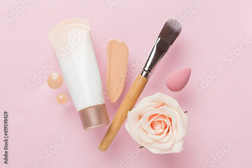 Obraz na plátně Composition with makeup foundation on color background, top view