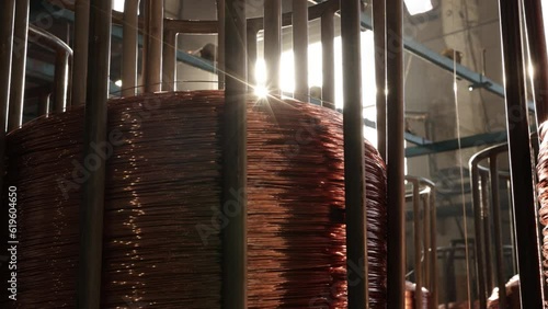 Coil storage, Bare copper, Plant efficiency. Wire manufacturing facility contains large coils copper wire.