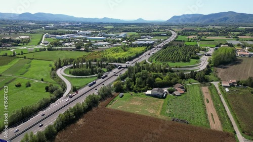 Loriol sur Drome - France, 6 June 2023: Panoramic aerial view of traffic on the sunny highway (Autoroute du Soleil A7) in the south of France, in the Drome region. photo
