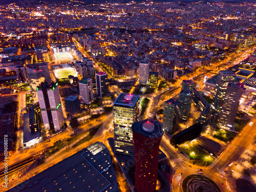 Picturesque view from drone of night Barcelona. Illuminated major business district with modern skyscrapers