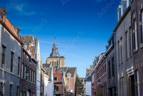 Sint Matthiaskerk church in a typical street in the city center of Maastricht, old street with residential buildings. Church of Saint Matthias is a Roman catholic church of the Netherlands.