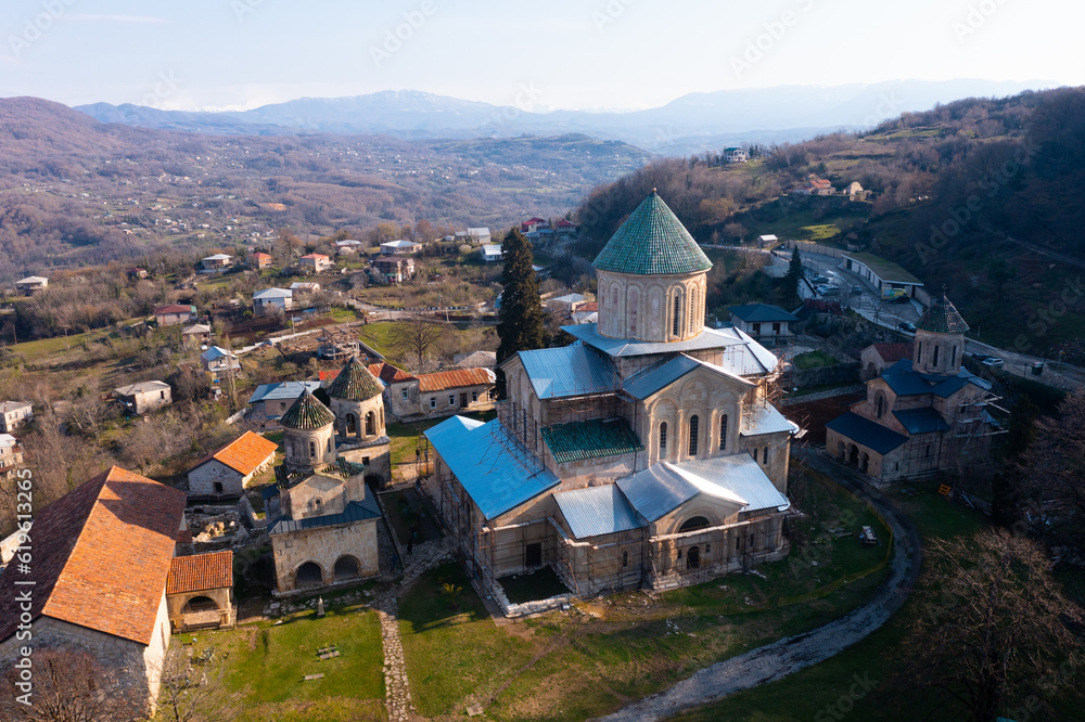 Scenic aerial view of medieval monastic complex of Gelati with partially restored main Cathedral of Nativity of Virgin in spring, Imereti region, Georgia.