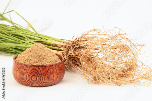 Vetiver grass or Vetiveria zizanioides roots and powder isolated on white background. photo
