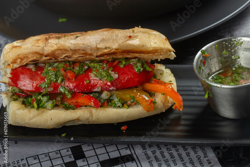 Delicious Argentinian choripan with chimichurri sauce