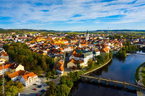 Scenic view from drone of historic center of small Czech town of Pisek on banks of Otava river on autumn day