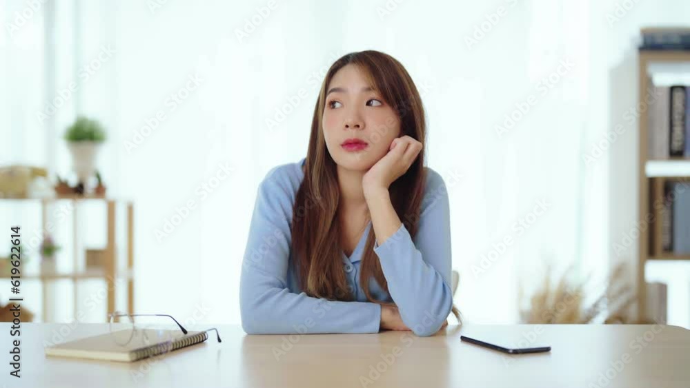 Distracted from work worried young asian woman thinking of problems. Pensive unmotivated lady looking at window, feeling lack of energy