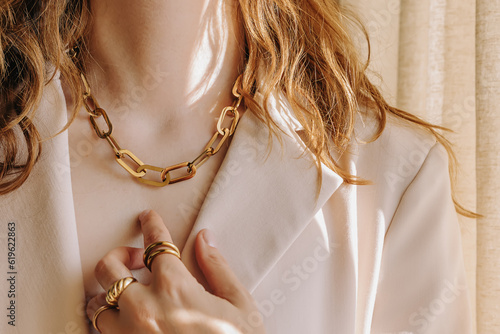 Fotografie, Obraz Unrecognizable woman wearing modern decorative jewelry close-up