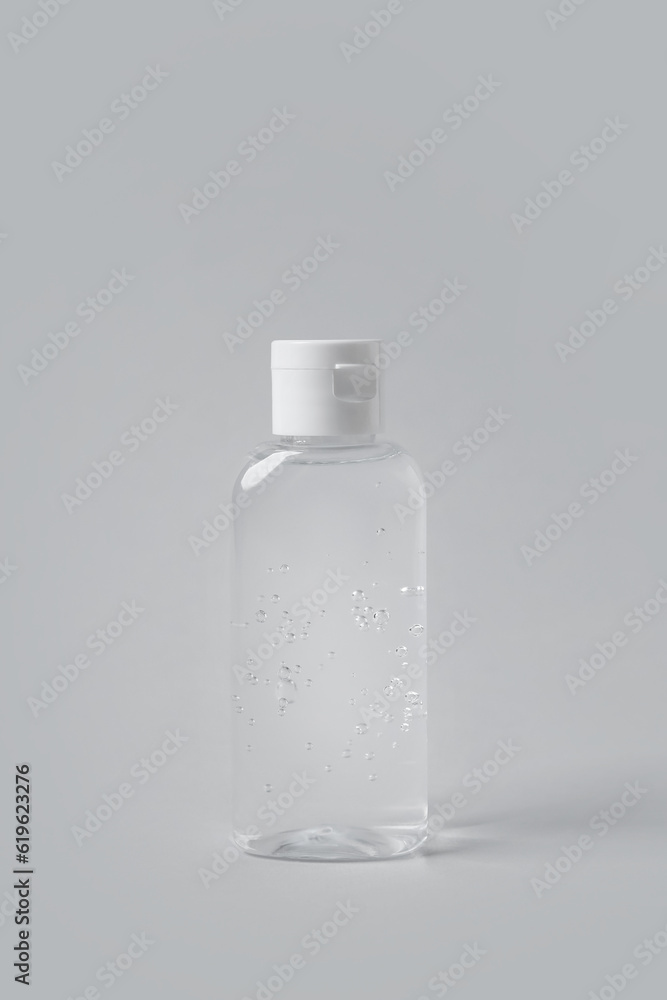 Bottle of cosmetic product on light grey background Bottle of cosmetic product on light grey background