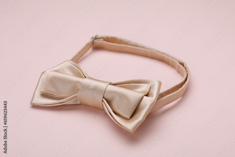 One stylish bow tie on beige background One stylish bow tie on beige background