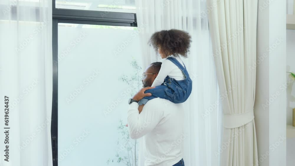 Happy african family parents and little children enjoy together and relaxing couple with kids having fun at home Happy african family parents and little children enjoy together and relaxing couple with kids having fun at home
