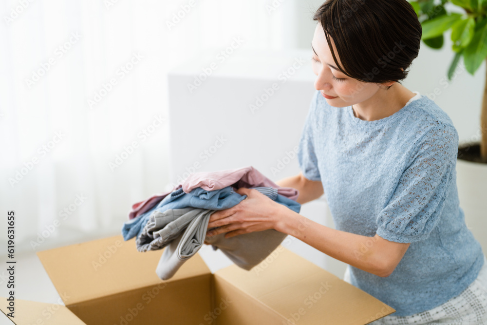段ボールから荷物を取り出す若い女性 引っ越しイメージ
段ボールから荷物を取り出す若い女性 引っ越しイメージ