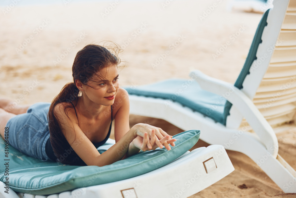 sand woman ocean sunbed smiling beach sea resort lifestyle lying beautiful