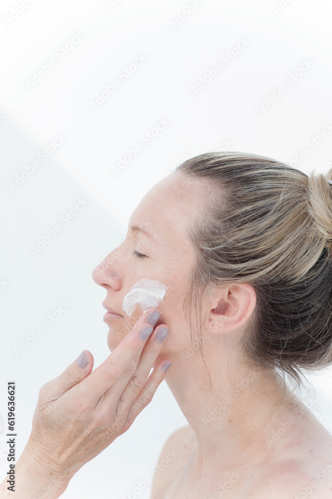 Photograph of a beautiful middle aged woman taken for a day spa photographed on white. Photograph of a beautiful middle aged woman taken for a day spa photographed on white.