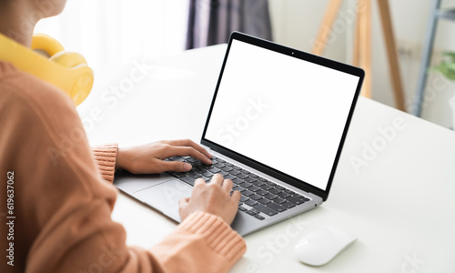 Woman hand working on laptop with blank copy space screen, mock-up for the application.