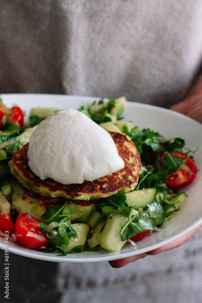 zucchini pancakes with vegetable salad and egg
