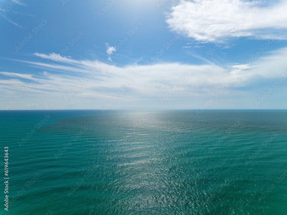 Fototapeta premium Beautiful sea surface background, Waves crashing in the ocean blue sky background.Open sea nature environment background