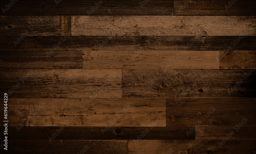 Dark stained reclaimed wood surface with aged boards lined up. Wooden