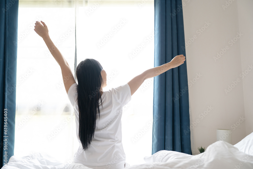 custom made wallpaper toronto digitalYoung asian woman sitting on the bed and stretch oneself in the morning at home