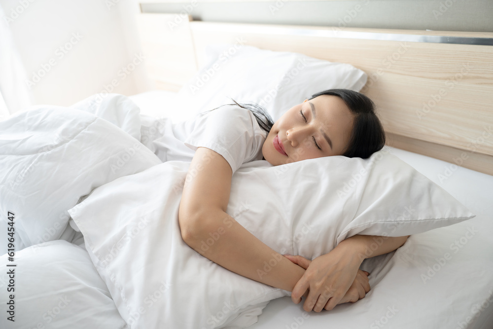 Beautiful Attractive Asian woman sleep and sweet dream lying on bed in cozy bedroom in the morning feeling so relax. Healthcare Concept. Beautiful Attractive Asian woman sleep and sweet dream lying on bed in cozy bedroom in the morning feeling so relax. Healthcare Concept.
