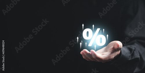 Fotografie Businessman showing percentage icon in hand