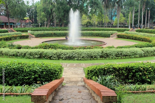 Jakarta – June 10, 2016:  Taman Rekreasi Wiladatika, Tree-lined paths, a swimming pool, a toy train & kids' play areas within a vast green space.  photo