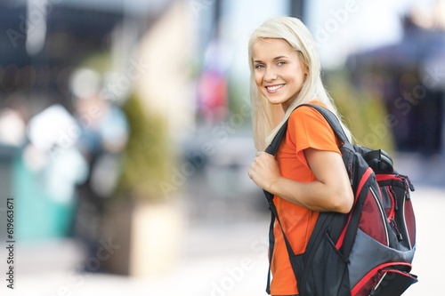 Young happy woman traveler posing