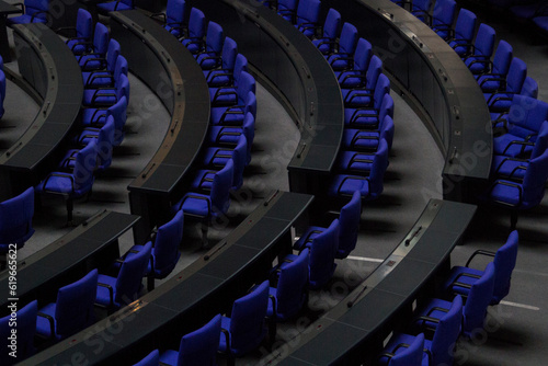 BERLIN, GERMANY - July 1, 2023, empty, blue seats at the Deutscher Bundestag. Reserved for the members of the parliament. The chairs have a special color: Reichstagsblau or Reichstags-Blue. photo