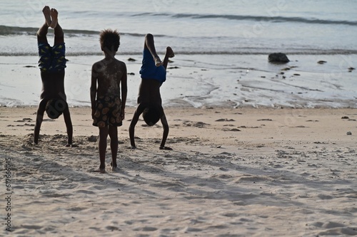 Fototapeta Torres Strait Islanders playing on the beach in Cape York Queenland Australia