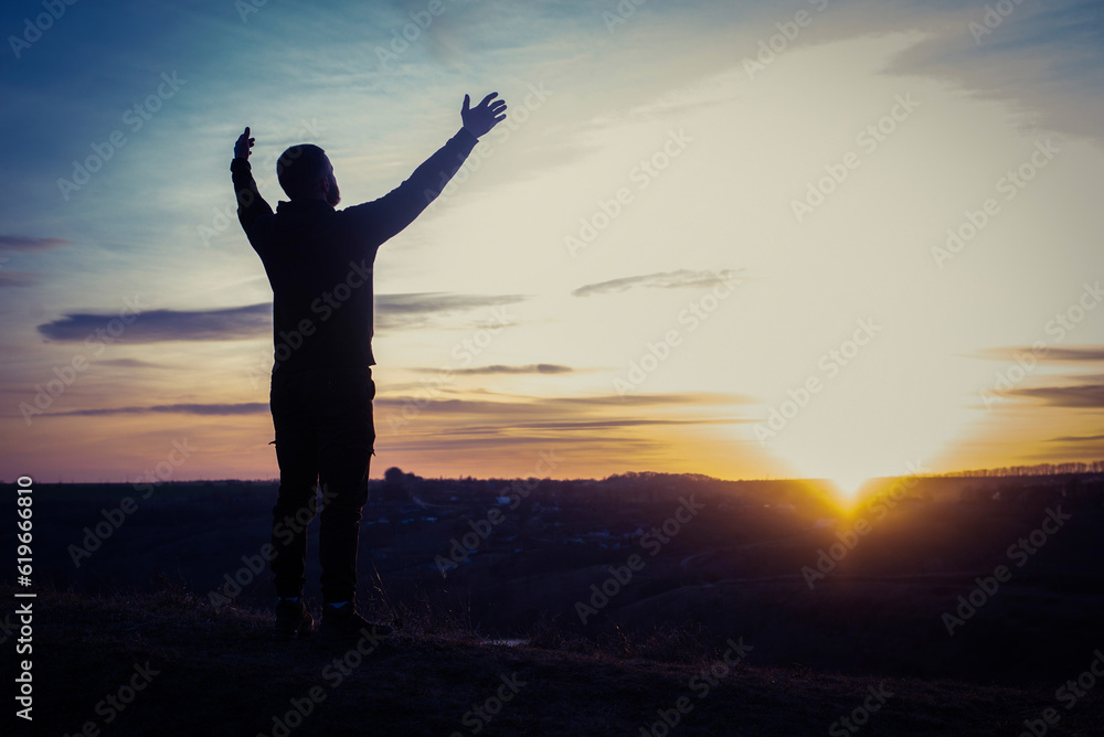 Prayer. Man on his knees praying. Against the background of the sky and sunset. Forgiveness of sins and repentance. Easter Prayer. Man on his knees praying. Against the background of the sky and sunset. Forgiveness of sins and repentance. Easter