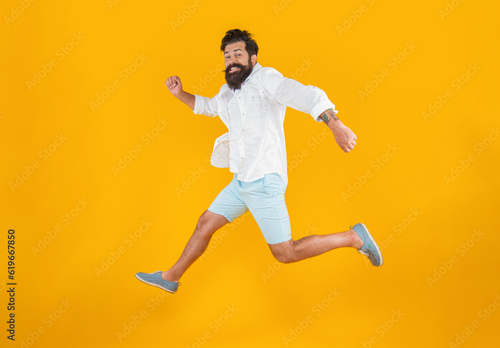 surprised bearded guy hurry on background. photo of bearded guy in a hurry wearing summer fashion
